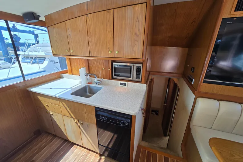  Yacht Photos Pics 1986 Ocean Yachts 55 Super Sport kitchen with wood cabinetry and modern appliances.