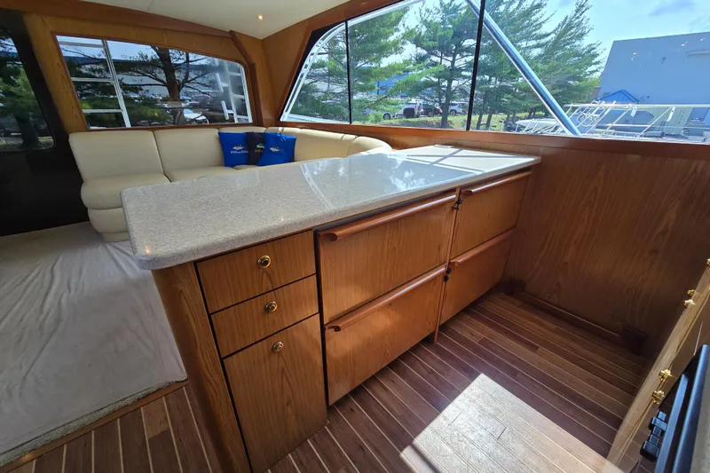  Yacht Photos Pics Interior of 1986 Ocean Yachts 55 Super Sport with wood cabinetry and seating area.