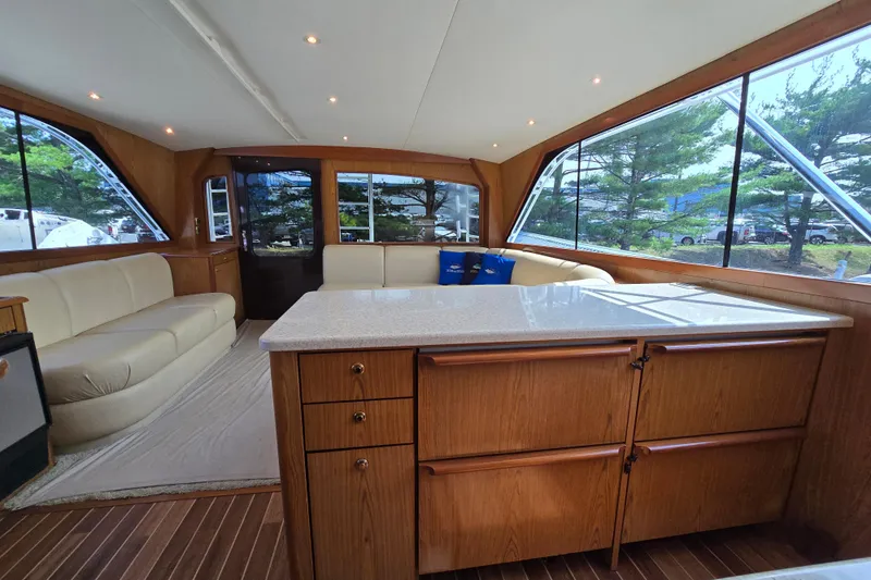  Yacht Photos Pics Luxurious interior of 1986 Ocean Yachts 55 Super Sport with elegant wood cabinetry and seating.