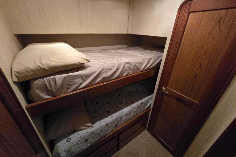  Yacht Photos Pics 1986 Ocean Yachts 55 Super Sport cabin with bunk beds and wooden door.