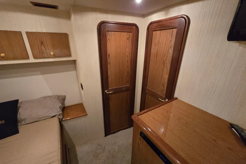  Yacht Photos Pics Interior of 1986 Ocean Yachts 55 Super Sport, featuring wooden doors and cozy cabin space.