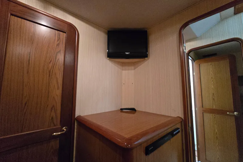  Yacht Photos Pics Interior of 1986 Ocean Yachts 55 Super Sport with wood paneling and mounted TV.