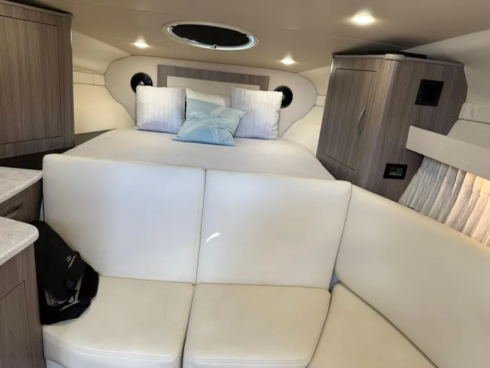  Yacht Photos Pics Luxurious interior of 2021 Regal 33 XO yacht with cozy bed and seating area.