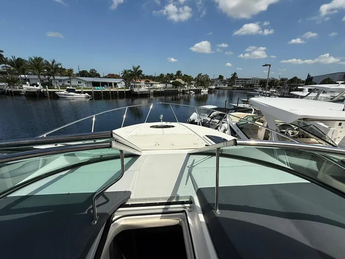  Yacht Photos Pics 2021 Regal 33 XO yacht docked in a sunny marina with clear skies.