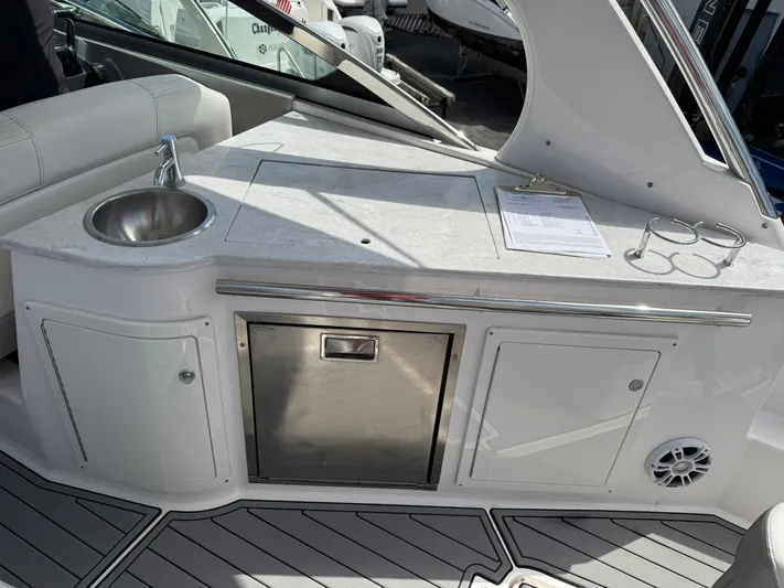 Yacht Photos Pics 2021 Regal 33 XO boat interior with sink, countertop, and storage compartments.