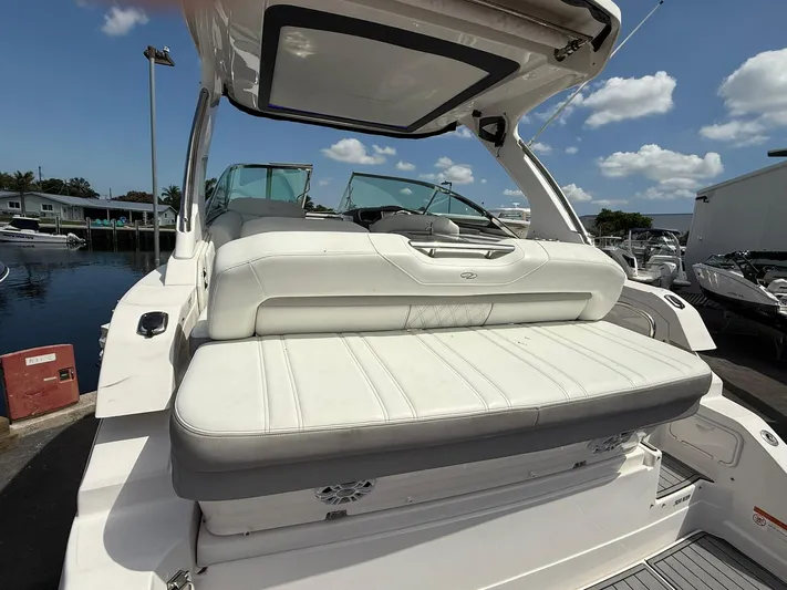 Yacht Photos Pics 2021 Regal 33 XO boat with white seating, docked under a clear blue sky.