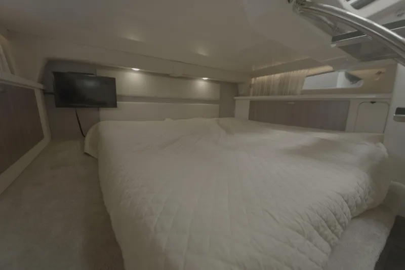 Yacht Photos Pics Luxurious interior cabin of 2021 Regal 33 XO yacht with cozy bedding and TV.