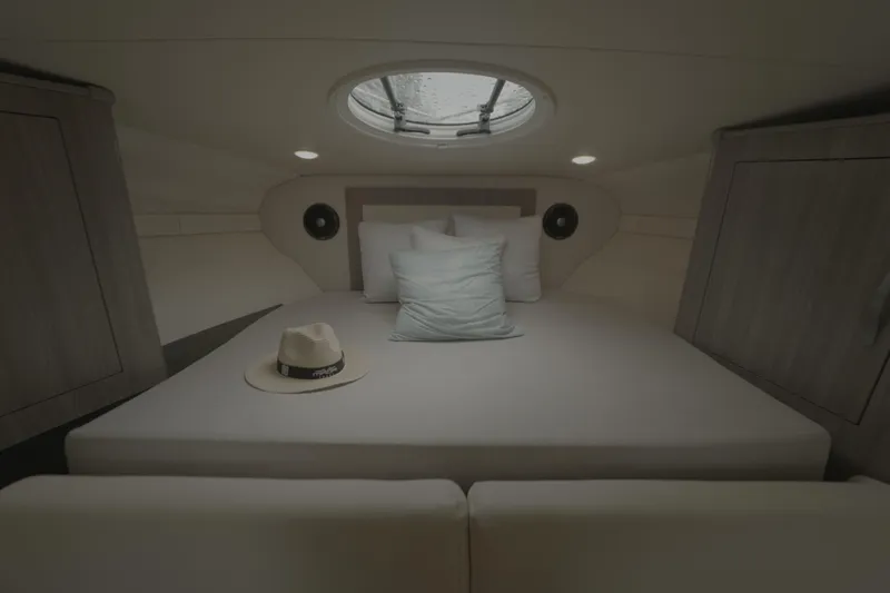 Yacht Photos Pics Cozy cabin interior of 2021 Regal 33 XO yacht with bed and hat.