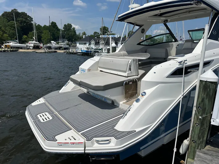  Yacht Photos Pics 2021 Sea Ray 320 Sundancer docked, showcasing sleek design and spacious deck.