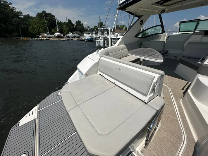  Yacht Photos Pics 2021 Sea Ray 320 Sundancer yacht with spacious deck and seating, docked by a marina.