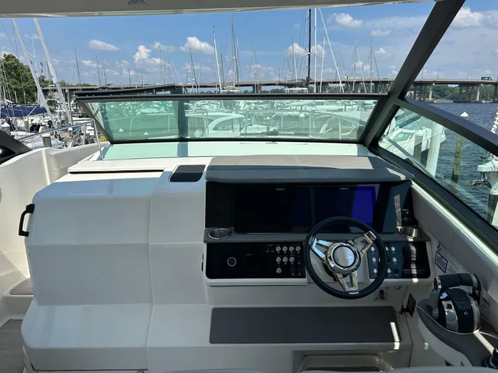  Yacht Photos Pics 2021 Sea Ray 320 Sundancer helm with modern controls and marina view.