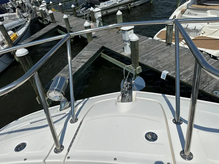  Yacht Photos Pics 2021 Sea Ray 320 Sundancer at marina dock, featuring stainless steel railings and anchor.