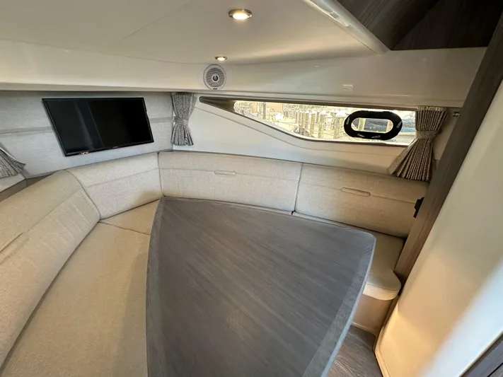  Yacht Photos Pics Interior of 2021 Sea Ray 320 Sundancer with cozy seating and mounted TV.