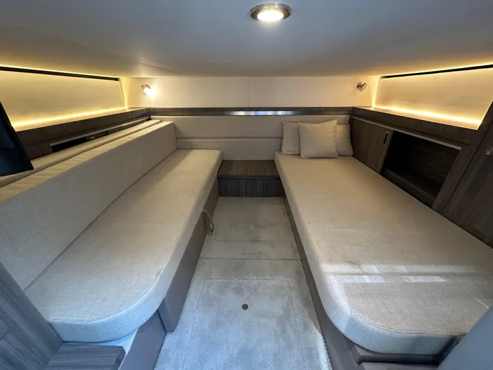  Yacht Photos Pics 2021 Sea Ray 320 Sundancer cabin interior with beige seating and ambient lighting.