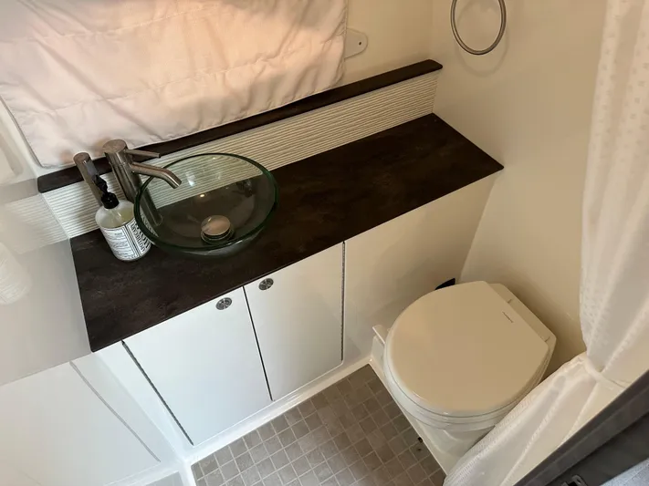  Yacht Photos Pics Modern bathroom in 2021 Sea Ray 320 Sundancer yacht with glass sink and toilet.