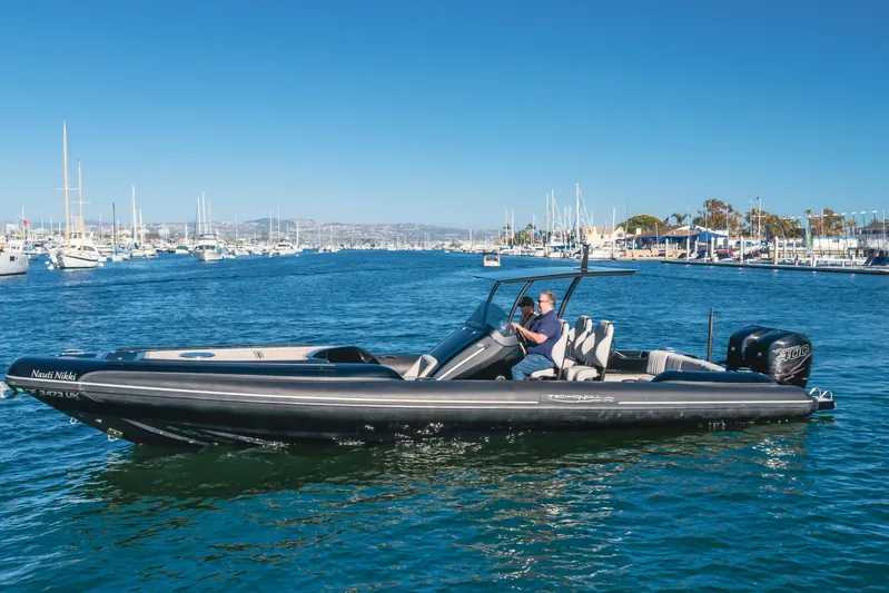  Yacht Photos Pics 2019 Technohull Sea DNA 999 boat cruising in a marina with clear blue skies.