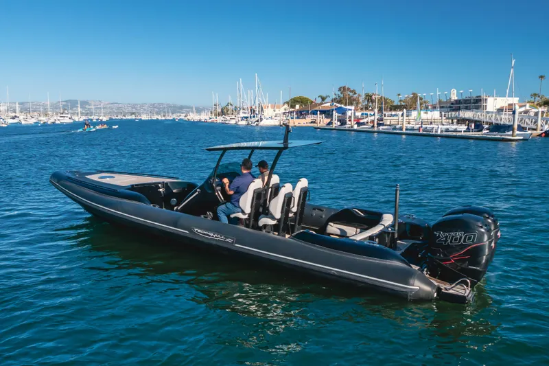  Yacht Photos Pics 2019 Technohull Sea DNA 999 boat cruising in a marina with clear blue water.