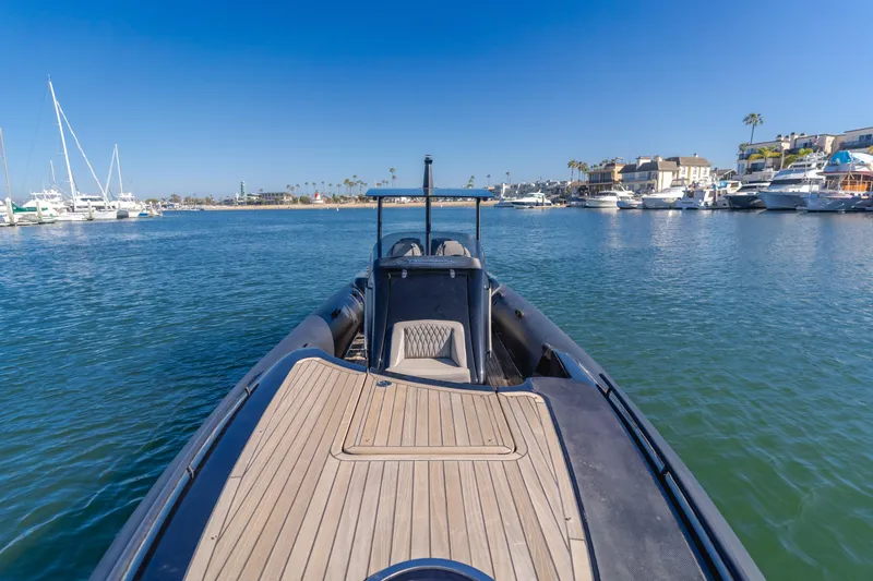  Yacht Photos Pics 2019 Technohull sea DNA 999 boat in a marina, clear blue sky, calm waters.