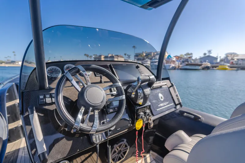  Yacht Photos Pics 2019 Technohull sea DNA 999 boat dashboard with steering wheel and controls, docked in marina.