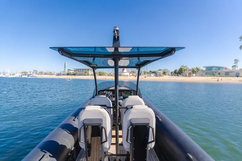  Yacht Photos Pics 2019 Technohull sea DNA 999 boat on calm water near a sandy beach.
