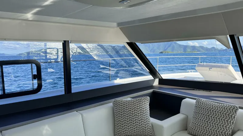 Pheonix Yacht Photos Pics Interior view of 2022 Fountaine Pajot MY6 yacht with ocean and mountain scenery.