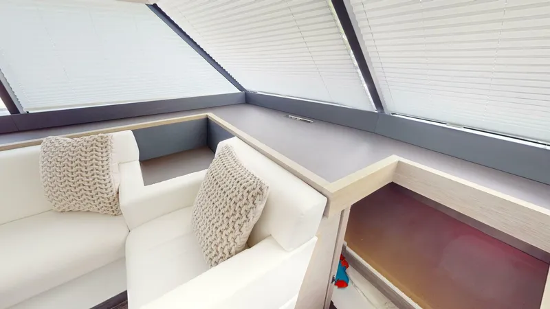 Pheonix Yacht Photos Pics Interior of 2022 Fountaine Pajot MY6 yacht with modern seating and cushions.