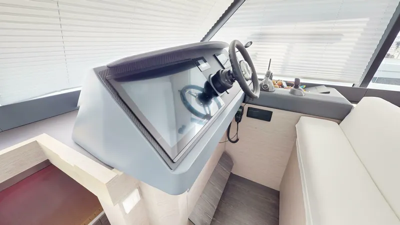Pheonix Yacht Photos Pics Helm station of 2022 Fountaine Pajot MY6 yacht with modern controls and steering wheel.