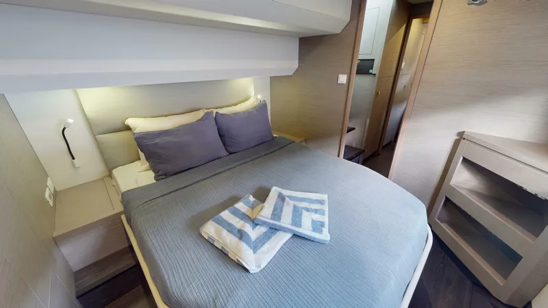 Pheonix Yacht Photos Pics Luxurious bedroom in 2022 Fountaine Pajot MY6 yacht with modern decor and cozy bedding.