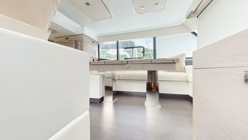 Pheonix Yacht Photos Pics Luxurious interior of 2022 Fountaine Pajot MY6 yacht with modern furnishings and large windows.