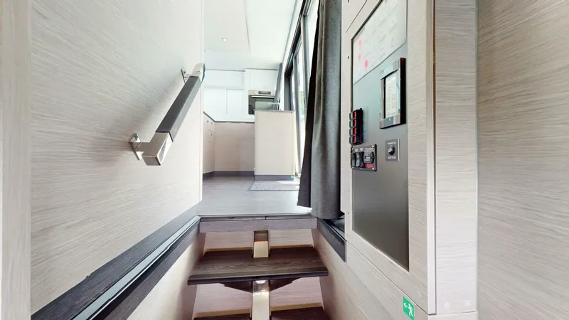 Pheonix Yacht Photos Pics Interior view of 2022 Fountaine Pajot MY6 yacht, featuring modern staircase and control panel.