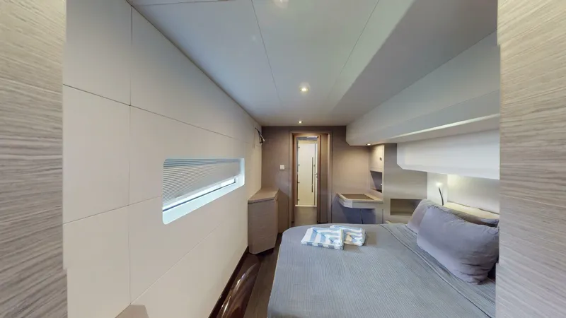 Pheonix Yacht Photos Pics Luxurious cabin interior of 2022 Fountaine Pajot MY6 yacht, featuring modern design and cozy bedding.