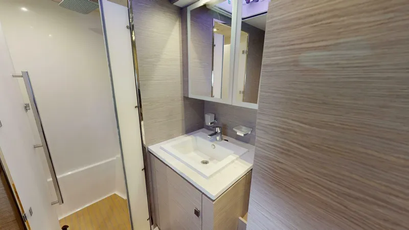 Pheonix Yacht Photos Pics Modern bathroom interior on 2022 Fountaine Pajot MY6 yacht, featuring sleek sink and shower.