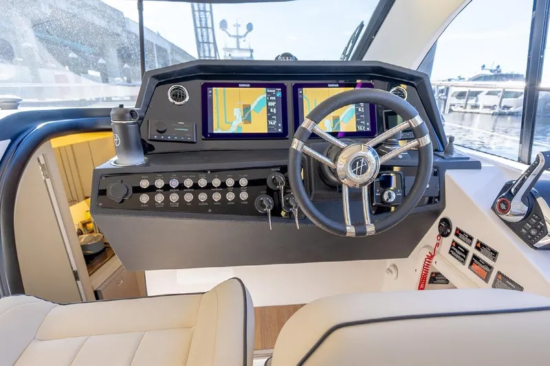  Yacht Photos Pics 2024 Hanover 415 Pure Gray yacht helm with navigation screens and controls.