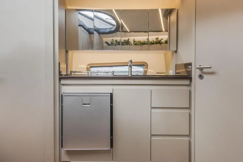  Yacht Photos Pics Modern kitchen interior in 2024 Hanover 415 Pure Gray, featuring sleek cabinetry and mirrored accents.