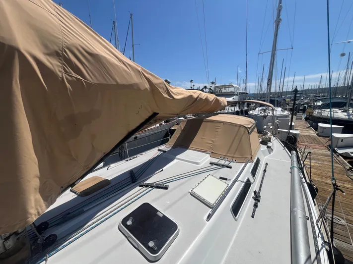 Medusa Yacht Photos Pics 1996 Santa Cruz 52 sailboat docked, featuring tan covers and clear blue sky.