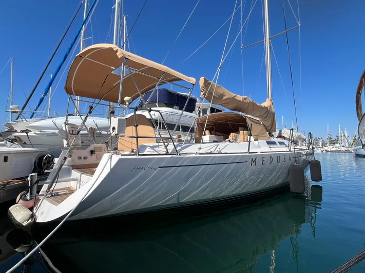Medusa Yacht Photos Pics Sailboat Santa Cruz 52, 1996 model, docked in a marina under clear blue skies.