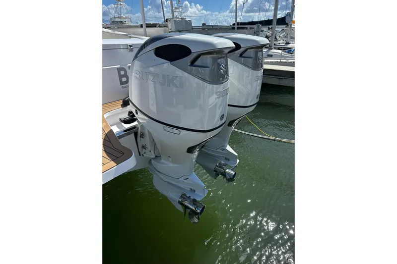  Yacht Photos Pics Twin Suzuki outboard engines on a 2022 Southport 30 FE boat, docked in a marina.