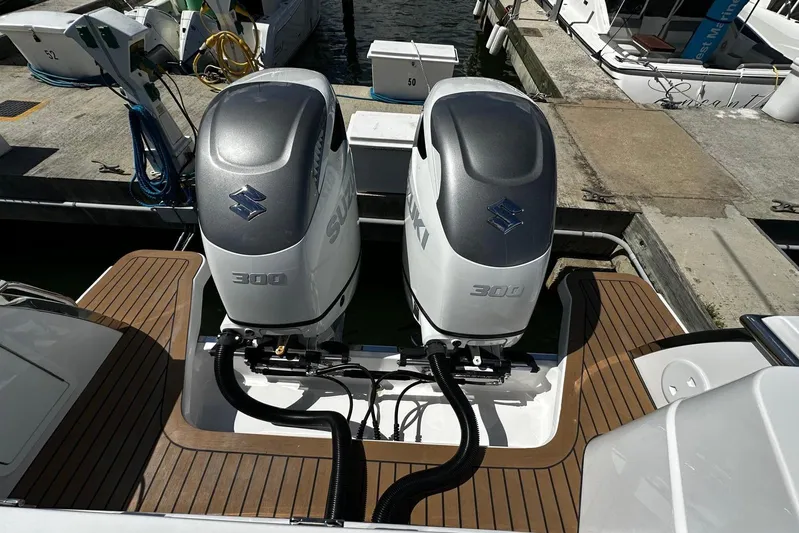  Yacht Photos Pics Twin Suzuki 300 outboard engines on a 2022 Southport 30 FE boat at a dock.