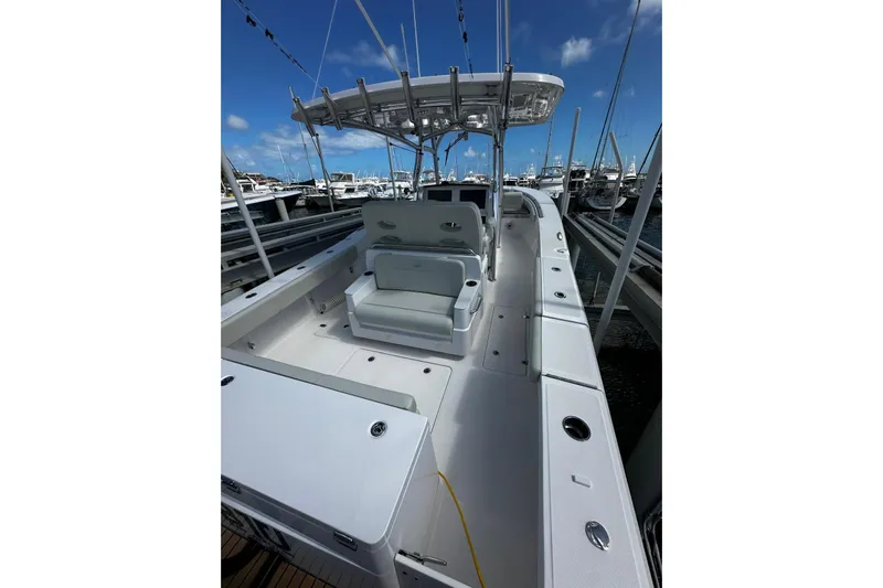  Yacht Photos Pics 2022 Southport 30 FE boat docked, featuring spacious seating and sleek design under a clear blue sky.