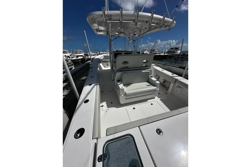  Yacht Photos Pics 2022 Southport 30 FE boat interior with seating and helm, docked under clear skies.