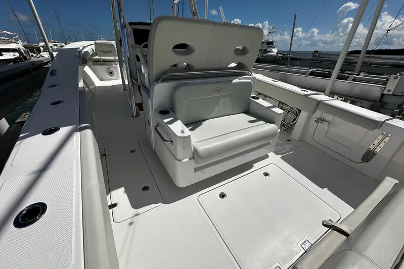  Yacht Photos Pics 2022 Southport 30 FE boat interior with seating and storage, docked under a clear sky.