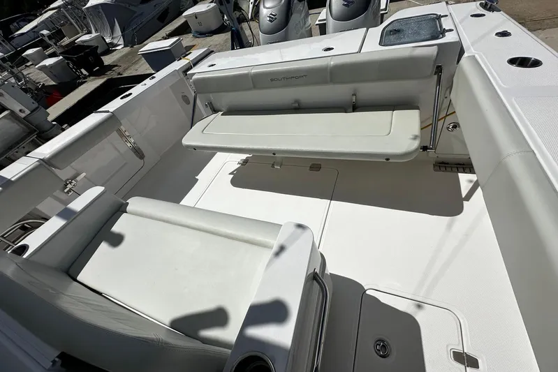  Yacht Photos Pics 2022 Southport 30 FE boat interior with cushioned seating and storage compartments.
