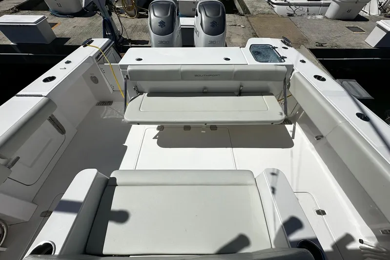  Yacht Photos Pics 2022 Southport 30 FE boat interior with seating and dual engines at dock.