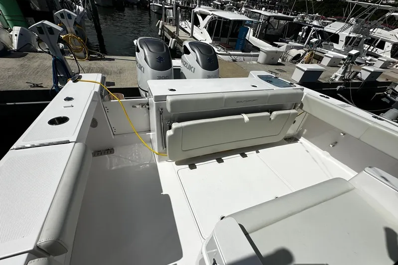  Yacht Photos Pics 2022 Southport 30 FE boat interior with seating and Suzuki engines at a marina.