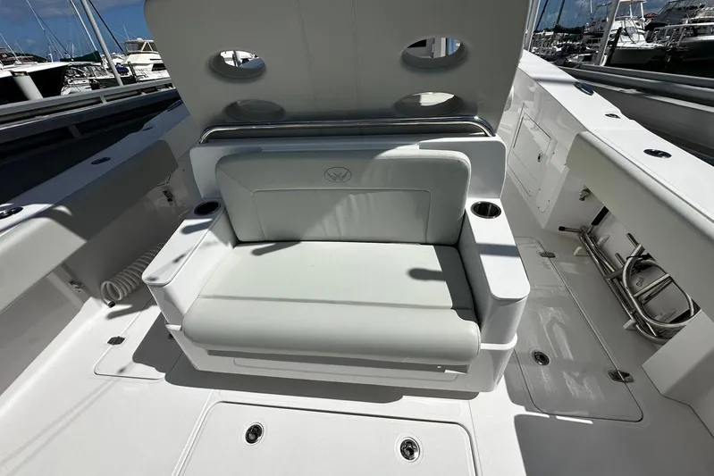  Yacht Photos Pics 2022 Southport 30 FE boat interior with cushioned seating and cup holders.