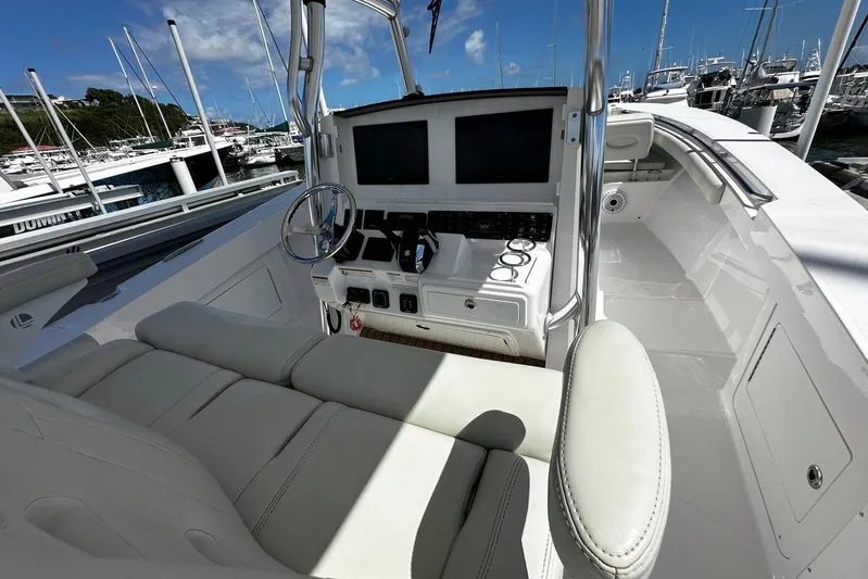  Yacht Photos Pics 2022 Southport 30 FE boat cockpit with modern controls and seating at a marina.