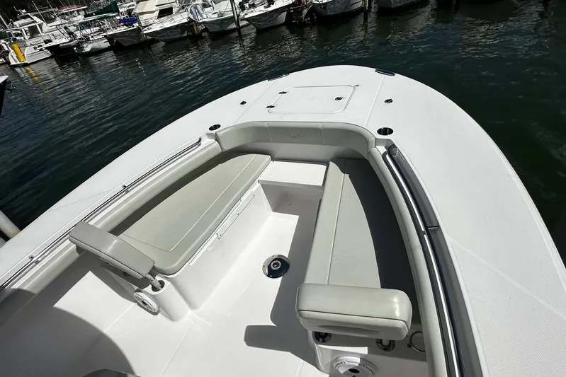  Yacht Photos Pics 2022 Southport 30 FE boat interior with cushioned seating, docked at marina.