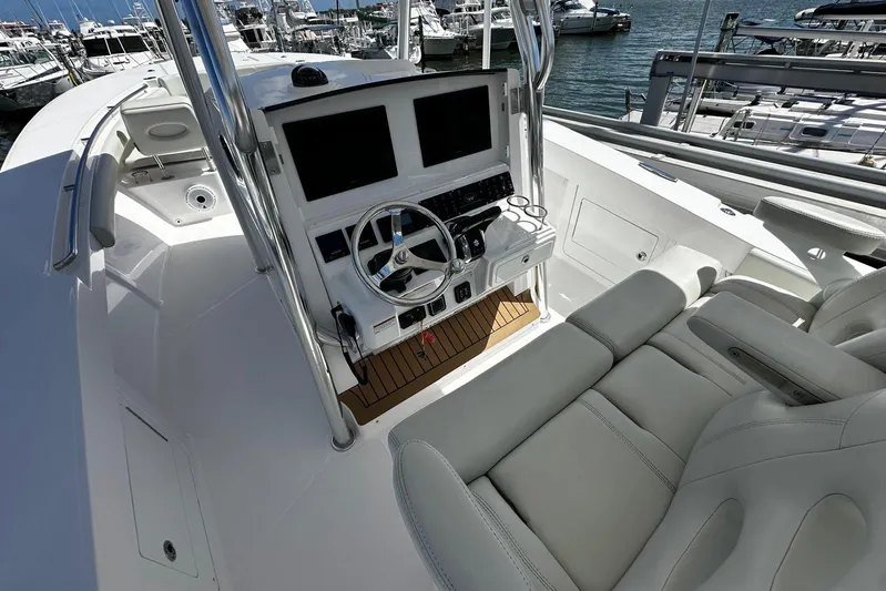  Yacht Photos Pics 2022 Southport 30 FE boat cockpit with modern controls and comfortable seating at marina.