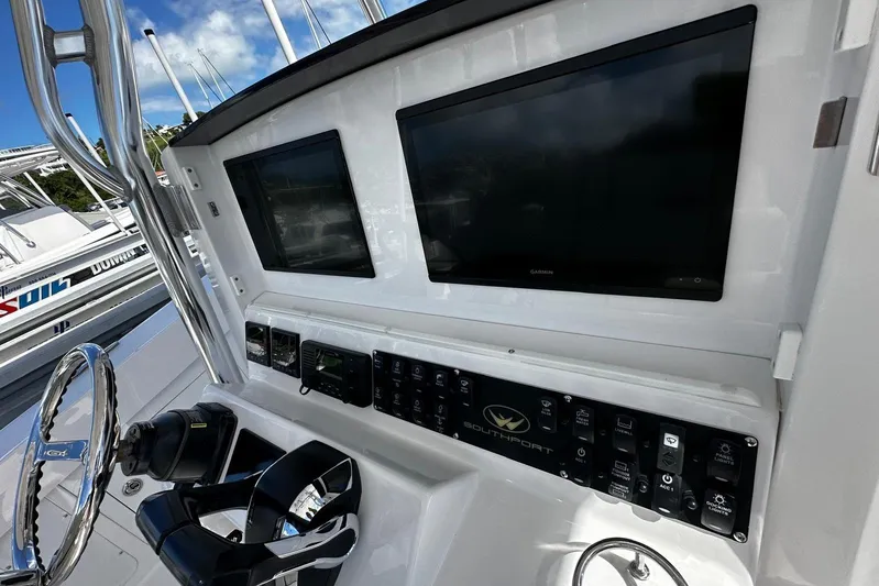  Yacht Photos Pics Control panel of 2022 Southport 30 FE boat with dual screens and steering wheel.