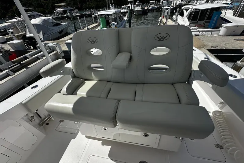  Yacht Photos Pics 2022 Southport 30 FE boat seating area at marina, featuring comfortable gray upholstery.